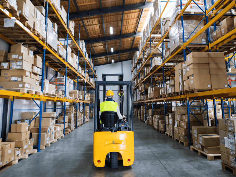 warehouse shelves with a forklift
