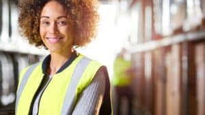 woman working in a warehouse and smiling