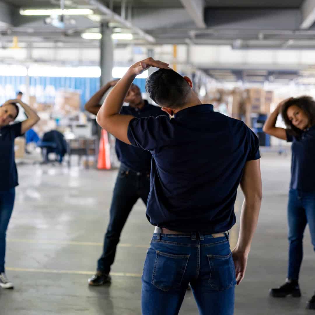 Employees stretching to prevent injury